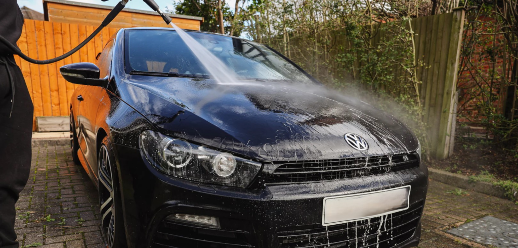 Image of black sports car being washed at driveway